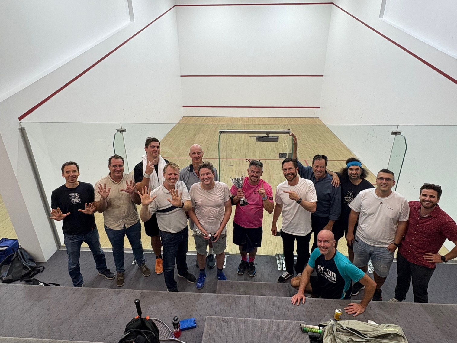 Players and friends celebrating the 2025 Christmas squash competition at the courts